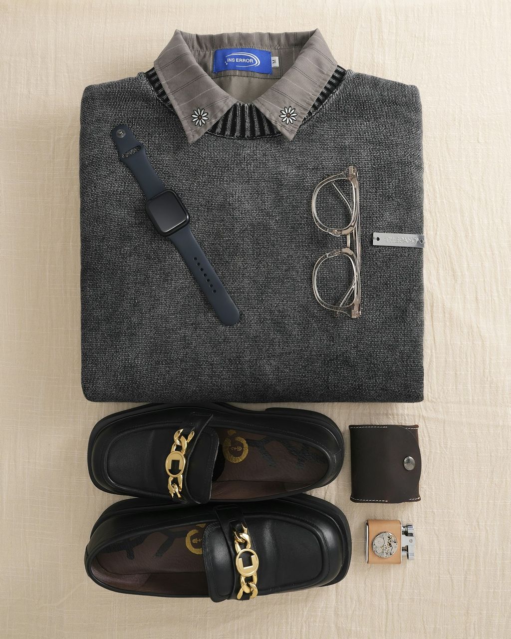 Menswear flat lay with knit sweater and accessories — e-commerce photography