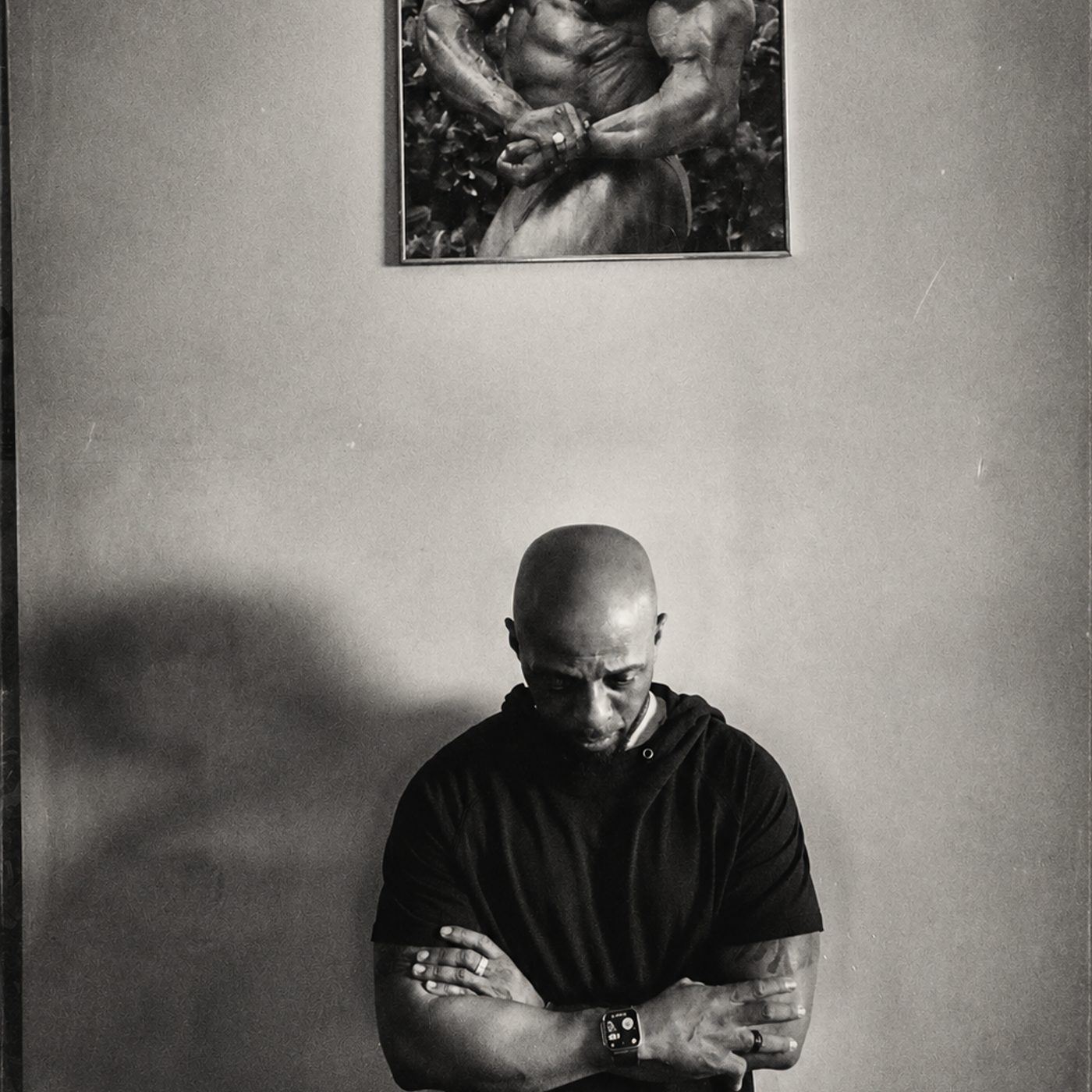 Athlete beneath a bodybuilder poster, fitness photography