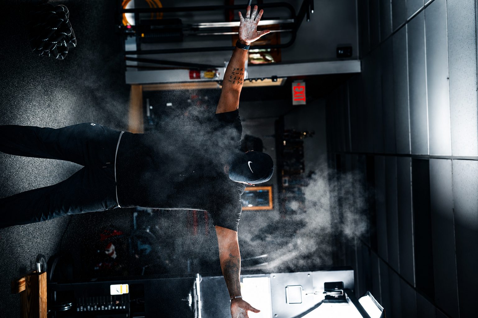 Chalk thrown mid-lift on the training floor — fitness photography
