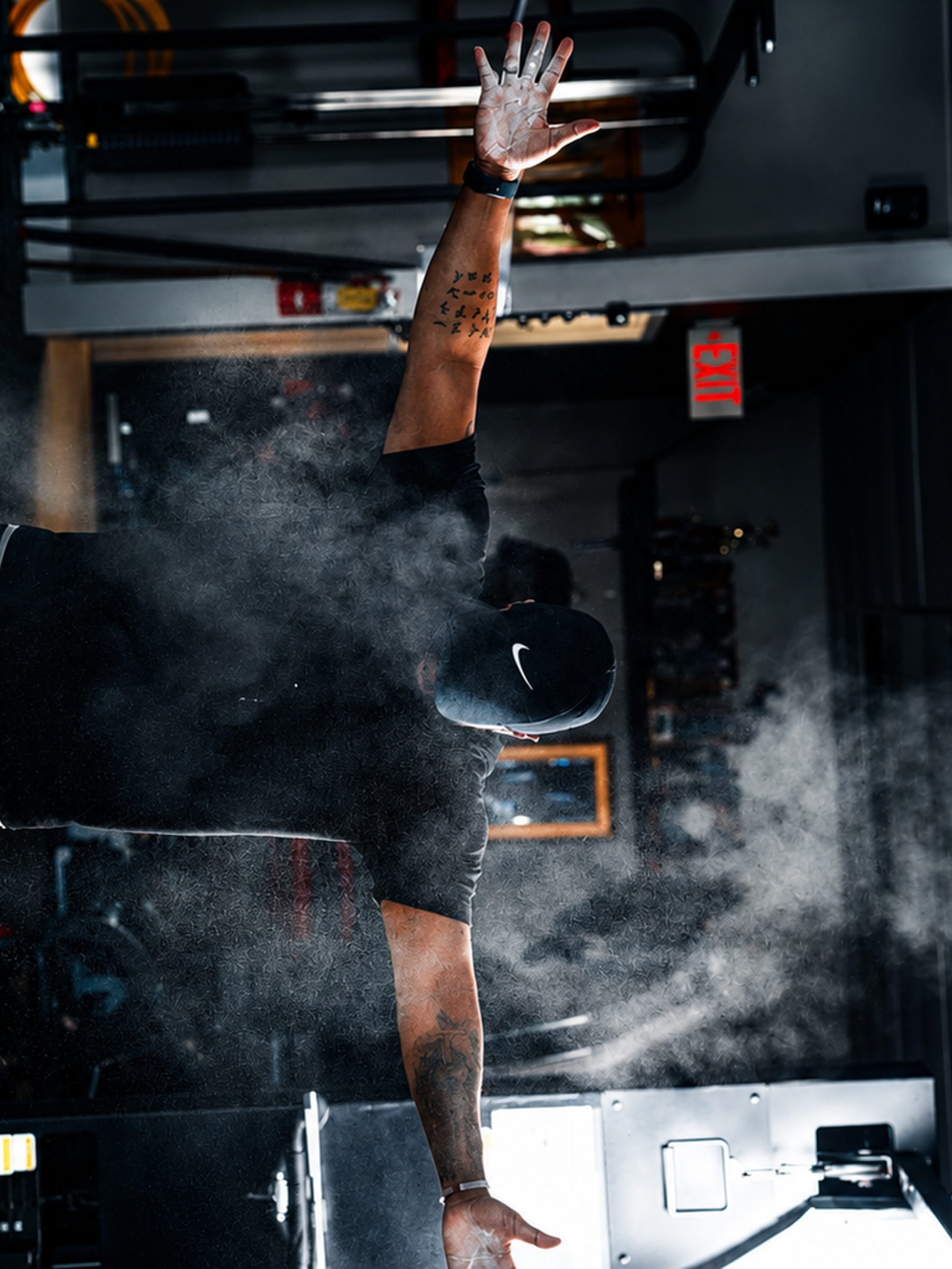 Chalk thrown mid-lift on the training floor, fitness photography