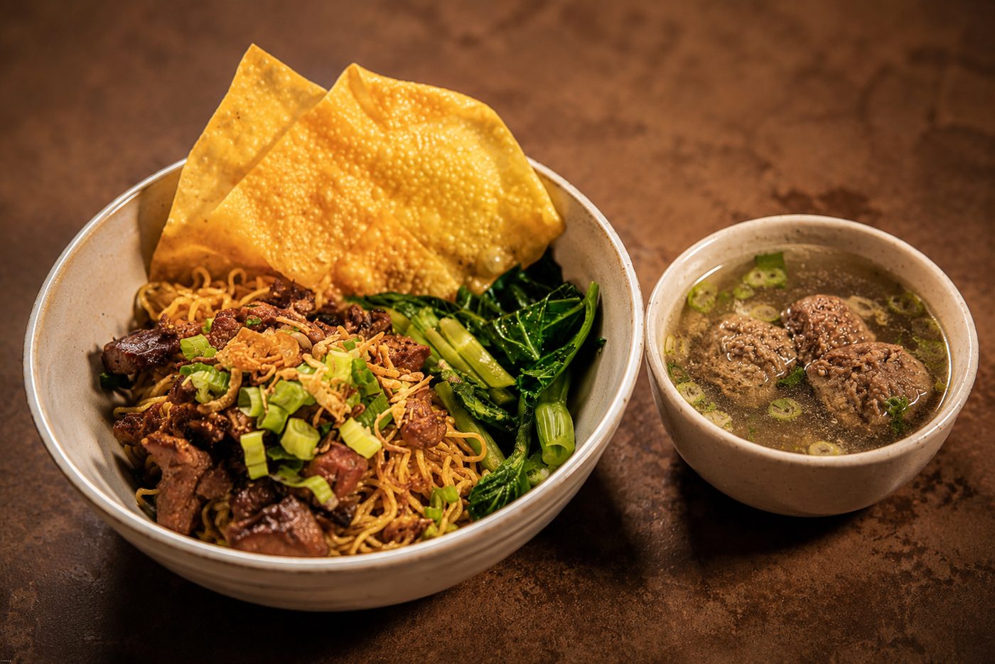 Egg noodles with braised beef, wontons, and beef-ball soup — Indonesian restaurant food photography