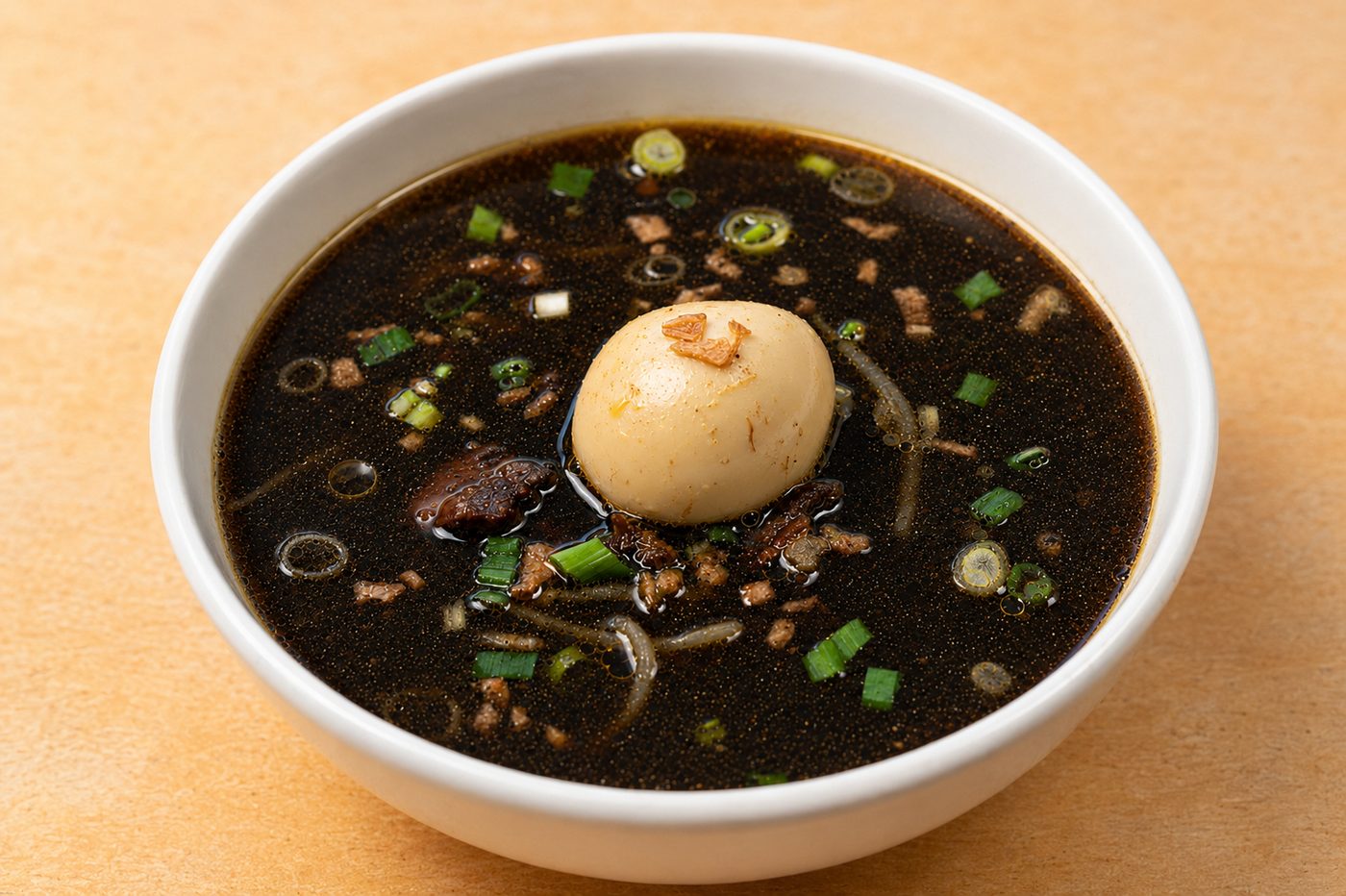 Rawon, East Javanese black beef soup with egg and scallion — Indonesian restaurant food photography