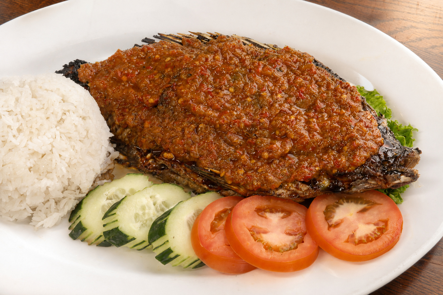 IBU: Ikan sambal, whole fish with chili sauce and rice — Indonesian restaurant food photography