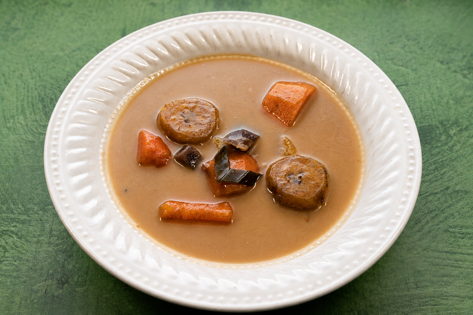 IBU: Mixed pieces in brown broth — Indonesian restaurant food photography