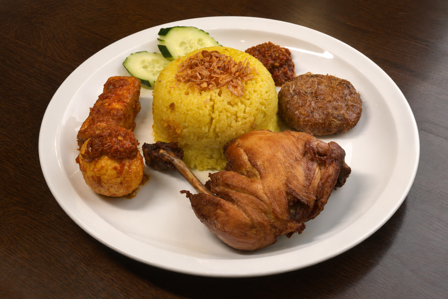 IBU: Nasi kuning, yellow rice with chicken egg and sides — Indonesian restaurant food photography