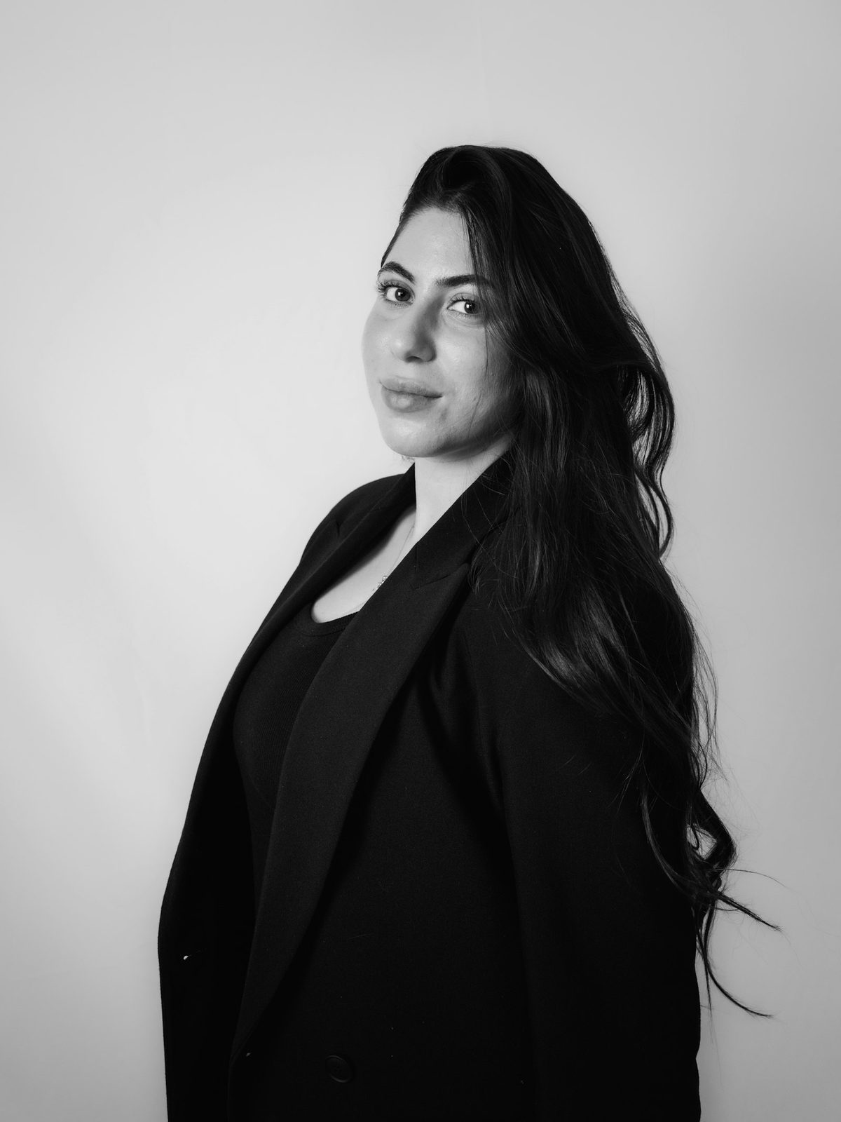 Professional woman in a black blazer — corporate portrait